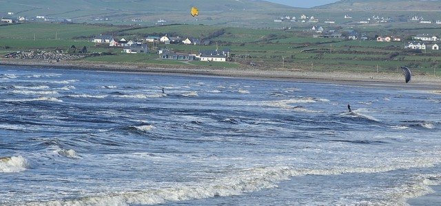 a pair of kite surfers making the most of the windy conditions